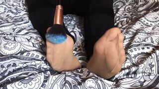 Feet tickling in nylon