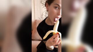 cute student licks her own banana in front of the camera.